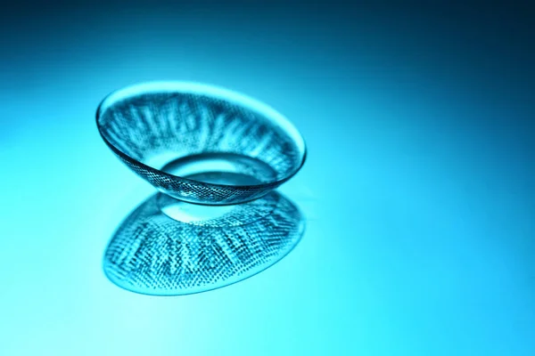 Contact lens on color background