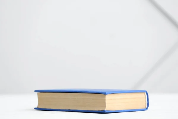 Book on table against light background — Stockfoto