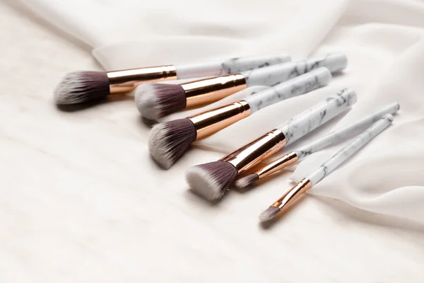 Set of makeup brushes on light background — Stock Photo, Image