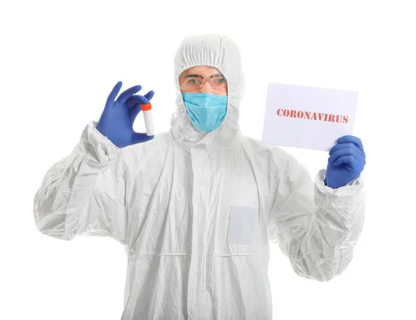 Laboratory worker in protective uniform holding sample in test tube and paper with text CORONAVIRUS on white background. Concept of epidemic — Stock Photo, Image