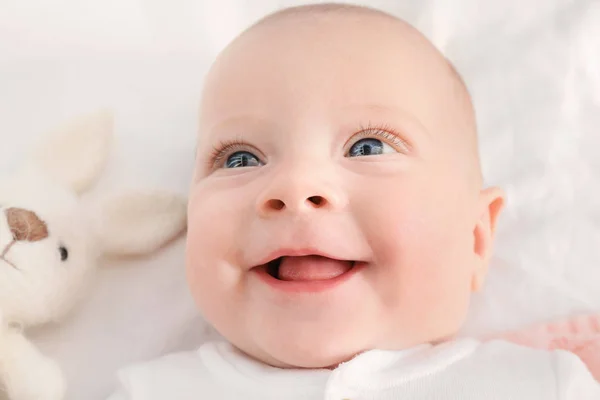 Portrait of cute little baby lying on bed, closeup — Stock Photo, Image