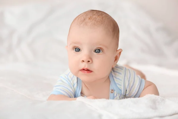 Portrait of cute little baby lying on bed — Stock Photo, Image