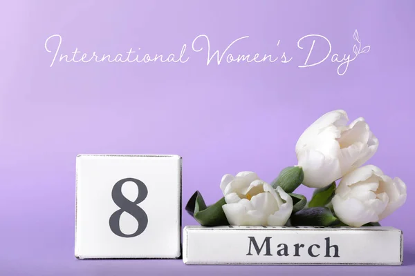 Calendar with date of International Women's Day and flowers on color background — 스톡 사진