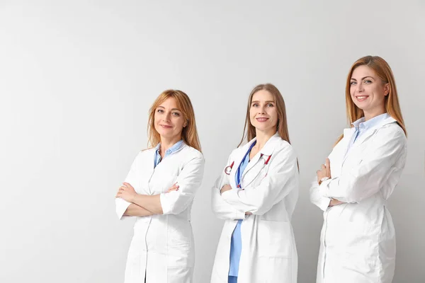 Portrait of female doctors on light background — Stock Photo, Image