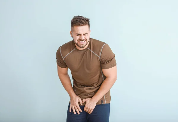 Young man with urologic disease on light background — Stock Photo, Image