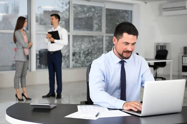 Businessman with colleagues in office — Stock Photo, Image