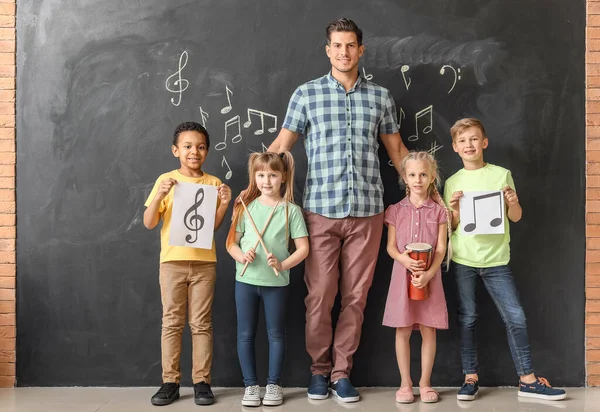 Musiklehrerin mit kleinen Kindern in der Schule — Stockfoto