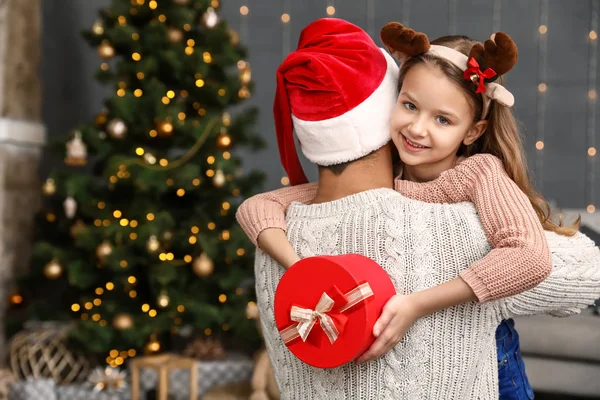 Little daughter with father and Christmas gift at home — Stock Photo, Image