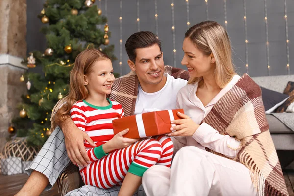 Happy family with Christmas gift at home — Stock Photo, Image