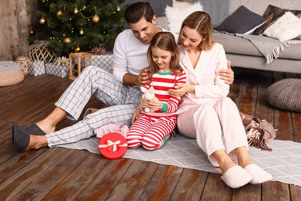 Família feliz com presente de Natal para a pequena filha em casa — Fotografia de Stock