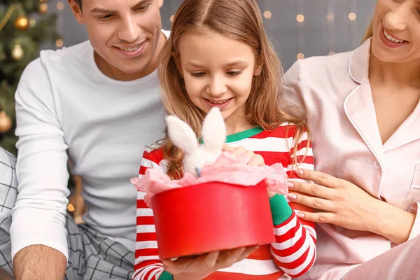 Happy family with Christmas gift for little daughter at home — Stock Photo, Image