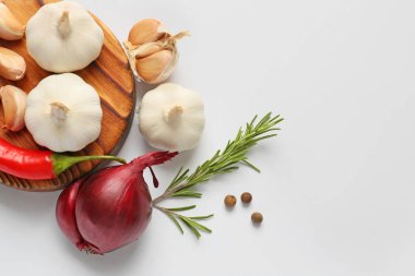 Garlic, spices and herbs on white background