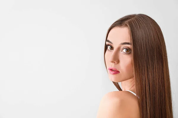 Beautiful woman with healthy long hair on white background — Stock Photo, Image