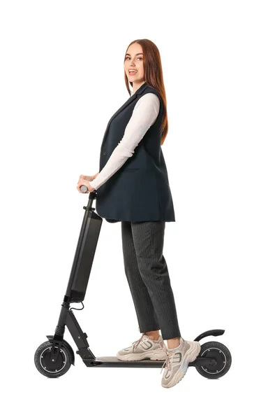 Young woman with kick scooter on white background — Stockfoto