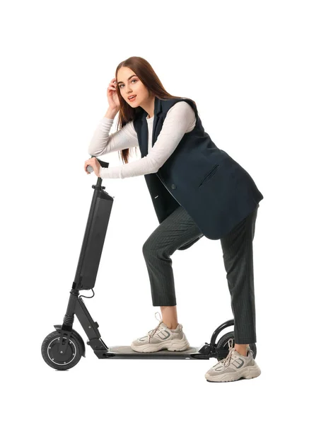 Young woman with kick scooter on white background — 스톡 사진