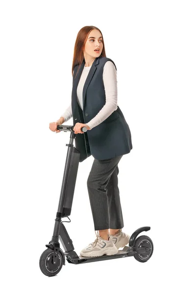 Young woman with kick scooter on white background — Stockfoto