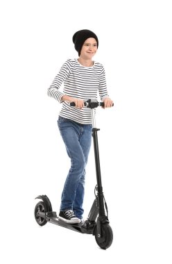 Teenage boy riding kick scooter on white background