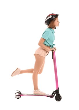Teenage girl riding kick scooter on white background