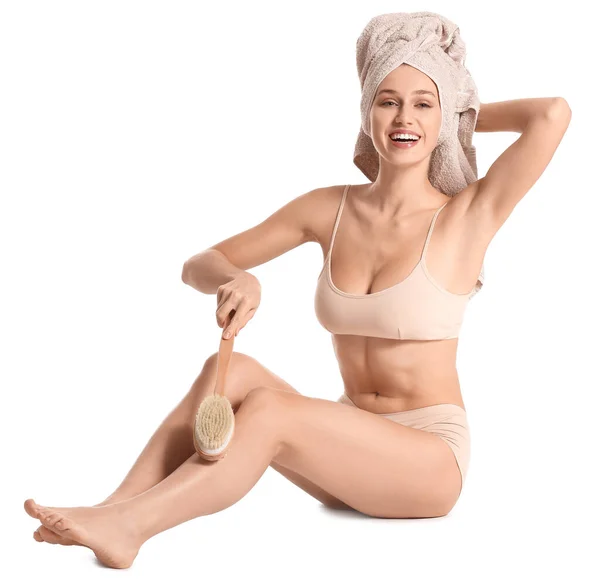 Beautiful young woman with massage brush on white background — Stock Photo, Image