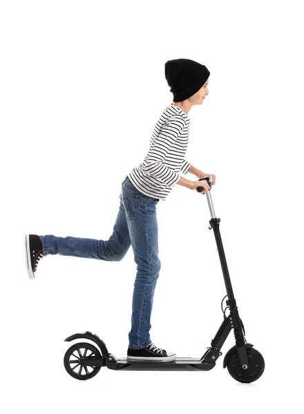 Teenage boy riding kick scooter on white background — ストック写真