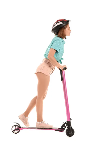 Teenage girl riding kick scooter on white background — Stock Photo, Image