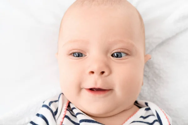 Portrait of cute little baby lying on bed — Stock Photo, Image