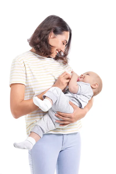 Mother feeding baby with milk from bottle on white background — Stock Photo, Image