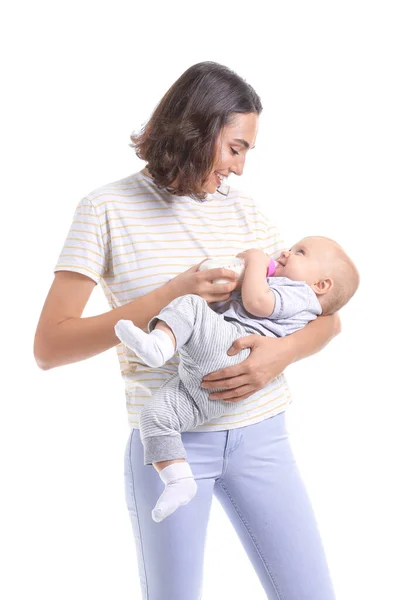 Mother feeding baby with milk from bottle on white background — Stok fotoğraf