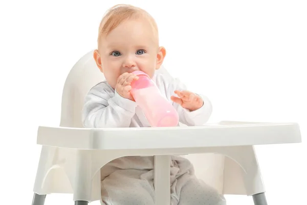 Baby with bottle of milk sitting in high-chair on white background — Stock Photo, Image