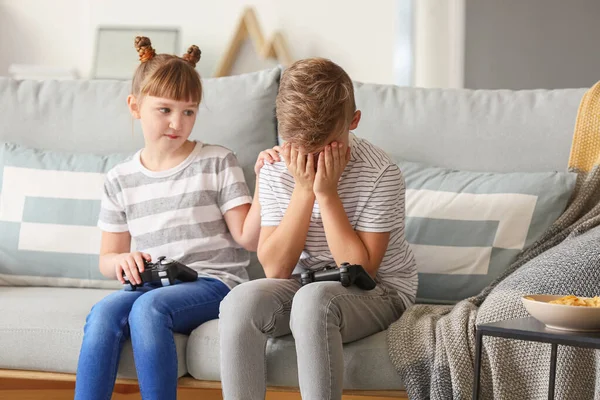 Little children playing video games at home — Stok fotoğraf