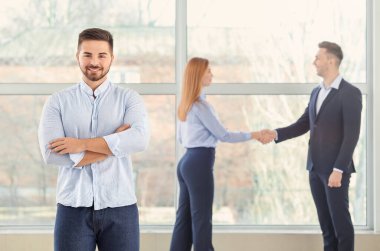 Portrait of young bank manager in office