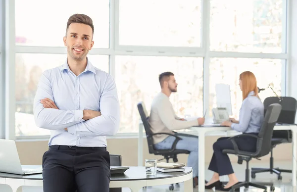 Portrait of young bank manager in office