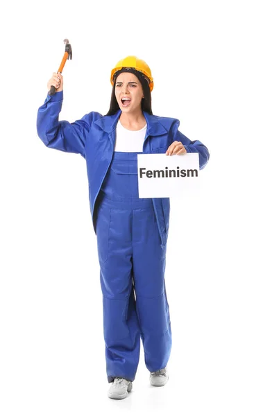 Trabalhadora segurando cartaz com texto FEMINISM contra fundo branco — Fotografia de Stock