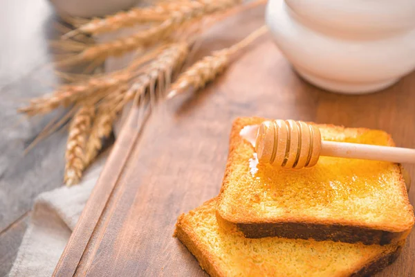 Toasted bread with honey on table — 스톡 사진