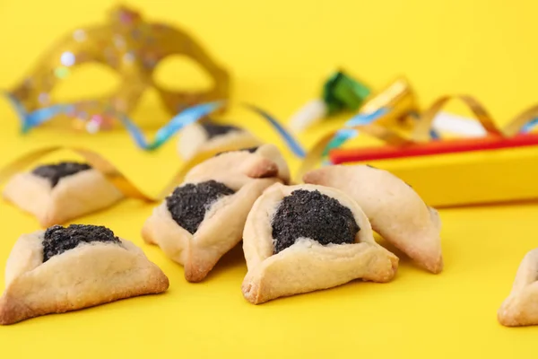 Tasty hamantaschen and party decor for Purim holiday on color background — Stock Photo, Image
