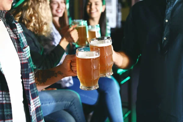 Young friends with beer celebrating St. Patrick's Day in pub, closeup — Stockfoto