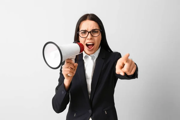 Screaming business woman with megaphone on light background. Concept of feminism — Stock Photo, Image