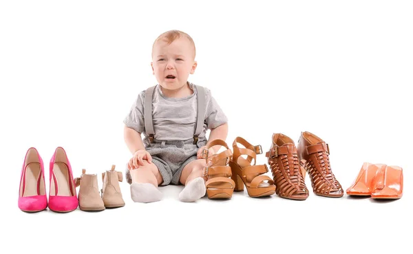Cute baby with stylish female shoes on white background — Stock Photo, Image
