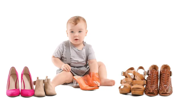 Cute baby with stylish female shoes on white background — Stock Photo, Image