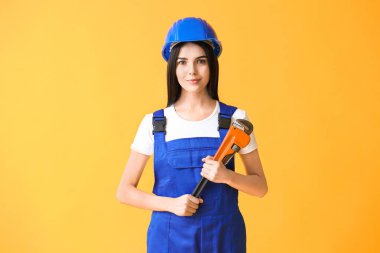 Female worker against color background. Concept of feminism