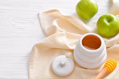 Sweet honey and apples on table