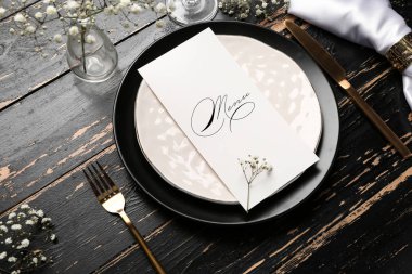 Beautiful table setting with menu on dark wooden background