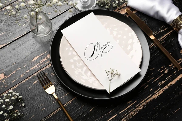 Beautiful table setting with menu on dark wooden background — Stockfoto