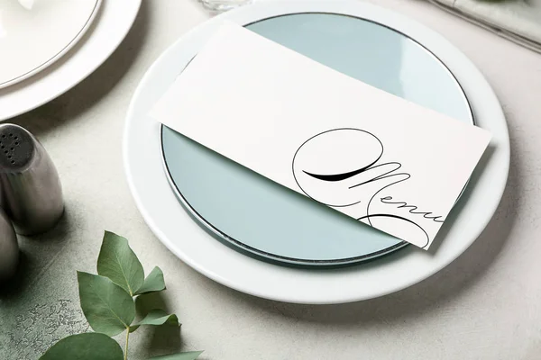 Beautiful table setting with menu on light background — 스톡 사진