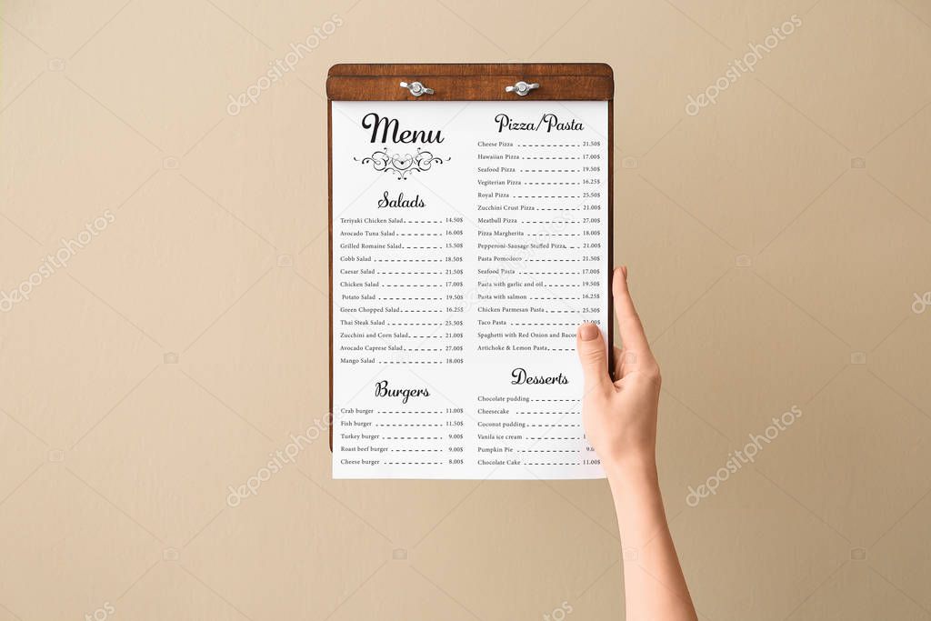 Female hand with menu on color background
