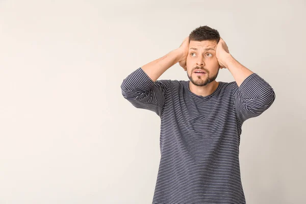 Stressed man on light background. Concept of choice — Stock Photo, Image
