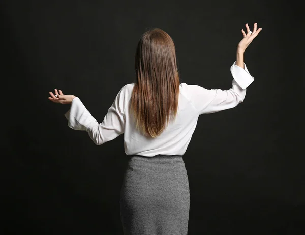 Helpless businesswoman on dark background. Concept of choice — Stock Photo, Image