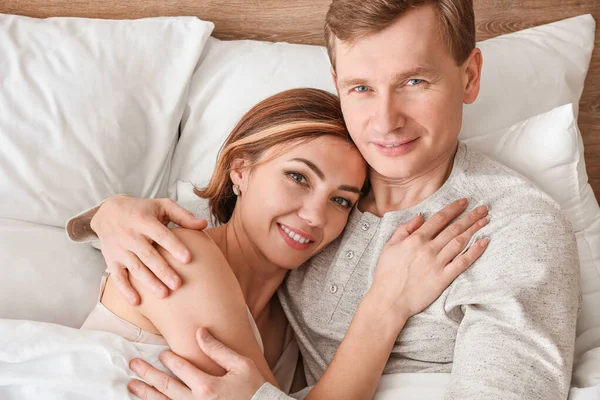 Beautiful couple lying in bed — Stock Photo, Image