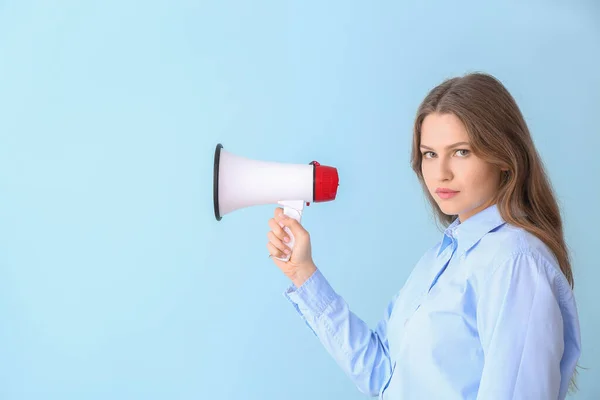 Young businesswoman with megaphone on color background — Stock Photo, Image