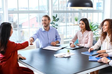 İnsan kaynakları yöneticisi başarılı bir röportajdan sonra başvuranla tokalaşıyor